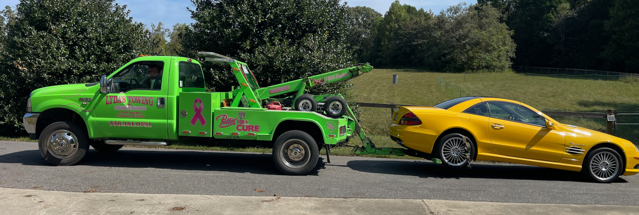 Green tow truck with the Banana behind it